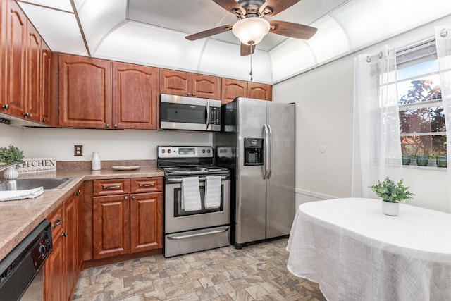 230 NE 26th Ave Unit 1030, Boynton Beach, FL 33435 - kitchen featuring a sink, stainless steel appliances, brown cabinets, and stone finish floor