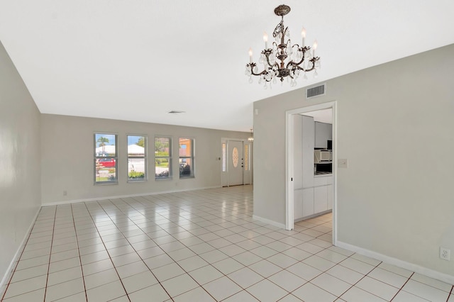 1746 W Terrace Dr, Lake Worth, FL 33460 - spare room with a chandelier, baseboards, and light tile patterned floors