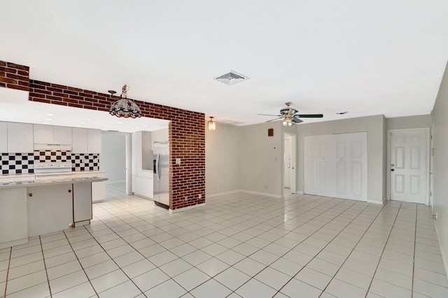 1746 W Terrace Dr, Lake Worth, FL 33460 - unfurnished living room with light tile patterned floors, a ceiling fan, and baseboards