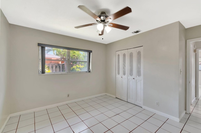 1746 W Terrace Dr, Lake Worth, FL 33460 - unfurnished bedroom with a closet, baseboards, light tile patterned flooring, and ceiling fan