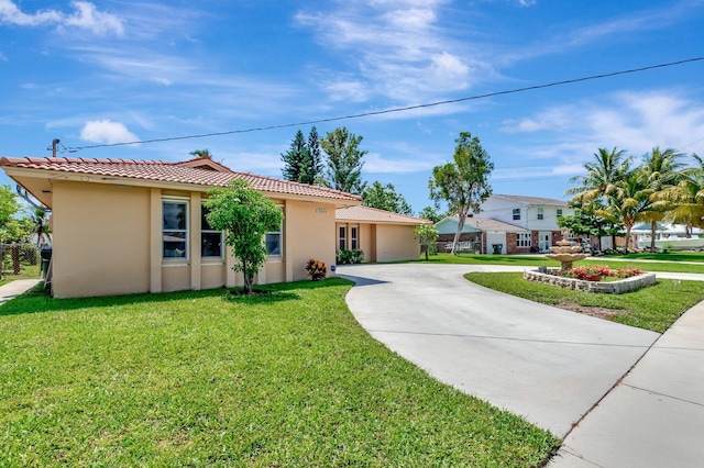 1746 W Terrace Dr, Lake Worth, FL 33460 - view of front of house with stucco siding, a tile roof, and a front lawn