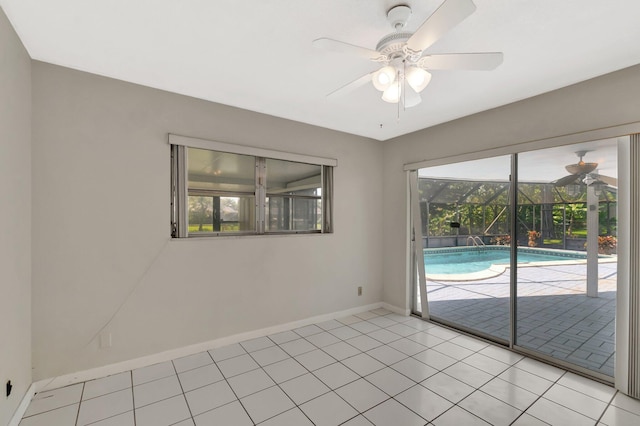 1746 W Terrace Dr, Lake Worth, FL 33460 - empty room with ceiling fan, baseboards, light tile patterned floors, and a sunroom