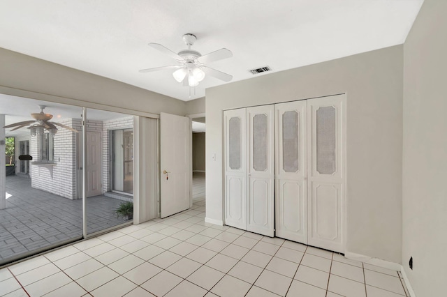 1746 W Terrace Dr, Lake Worth, FL 33460 - unfurnished bedroom featuring access to exterior, a ceiling fan, light tile patterned floors, and baseboards