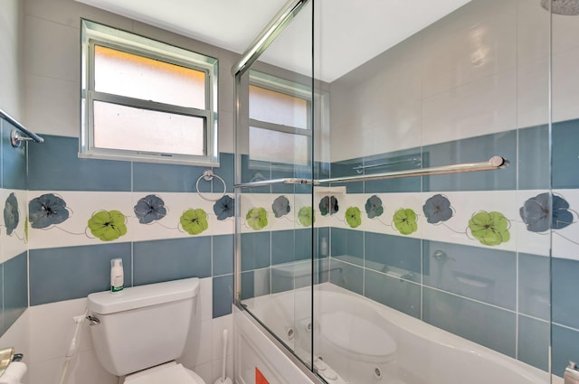 1746 W Terrace Dr, Lake Worth, FL 33460 - bathroom featuring tile walls, toilet, and enclosed tub / shower combo