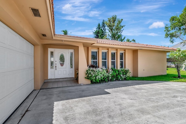 1746 W Terrace Dr, Lake Worth, FL 33460 - doorway to property featuring stucco siding and a tile roof