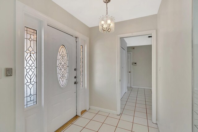 1746 W Terrace Dr, Lake Worth, FL 33460 - entrance foyer with a chandelier, baseboards, and light tile patterned floors