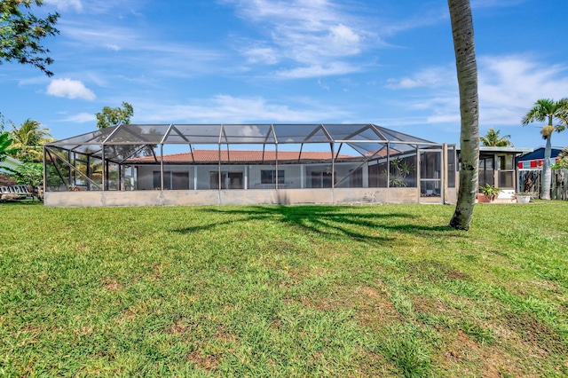1746 W Terrace Dr, Lake Worth, FL 33460 - rear view of house featuring a lawn and glass enclosure