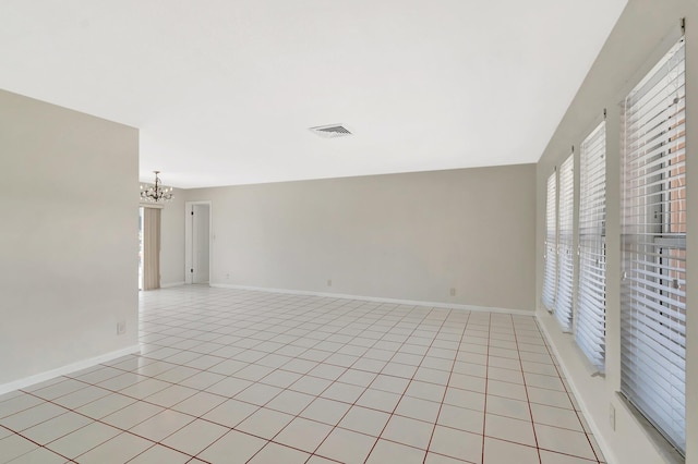 1746 W Terrace Dr, Lake Worth, FL 33460 - empty room featuring a chandelier, baseboards, and light tile patterned floors