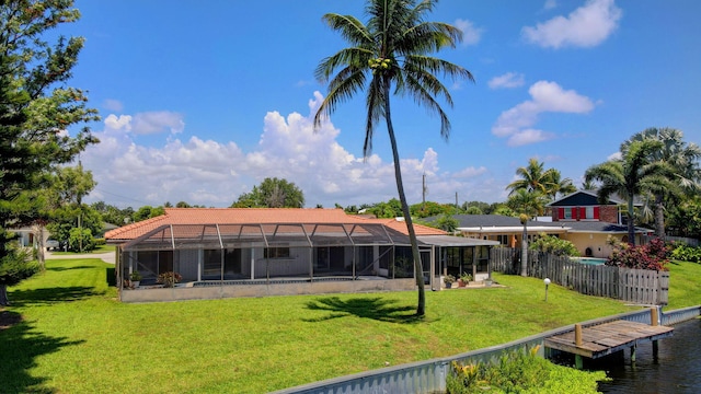 1746 W Terrace Dr, Lake Worth, FL 33460 - rear view of house with glass enclosure, a tile roof, and a water view