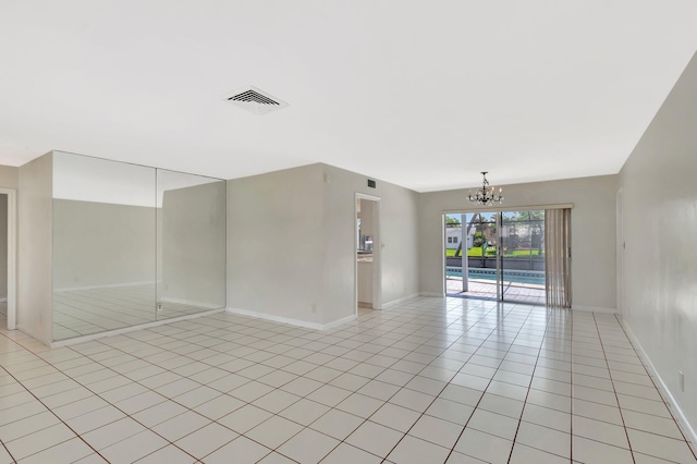 1746 W Terrace Dr, Lake Worth, FL 33460 - empty room featuring a chandelier, light tile patterned floors, and baseboards