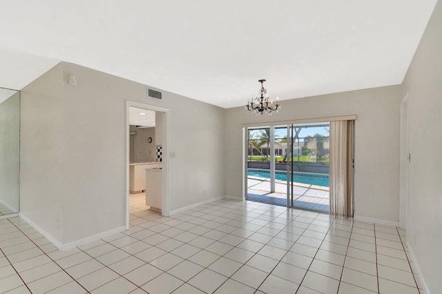 1746 W Terrace Dr, Lake Worth, FL 33460 - unfurnished room with a chandelier, baseboards, and light tile patterned floors