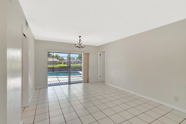 1746 W Terrace Dr, Lake Worth, FL 33460 - spare room featuring a chandelier, baseboards, and light tile patterned flooring