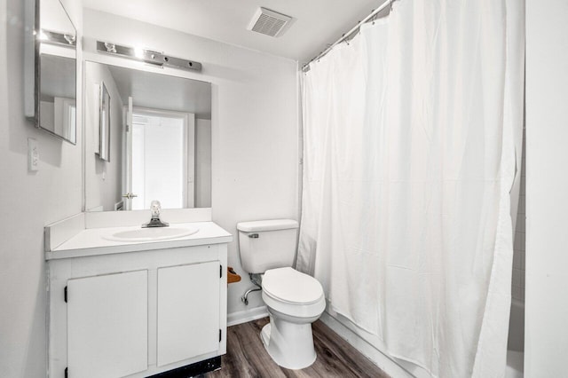 full bathroom with toilet, vanity, a shower with curtain, wood finished floors, and visible vents