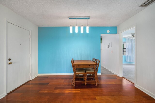 2050 Oleander Blvd Unit 3-206, Fort Pierce, FL 34950 - dining area with a textured ceiling, wood finished floors, baseboards, and rail lighting