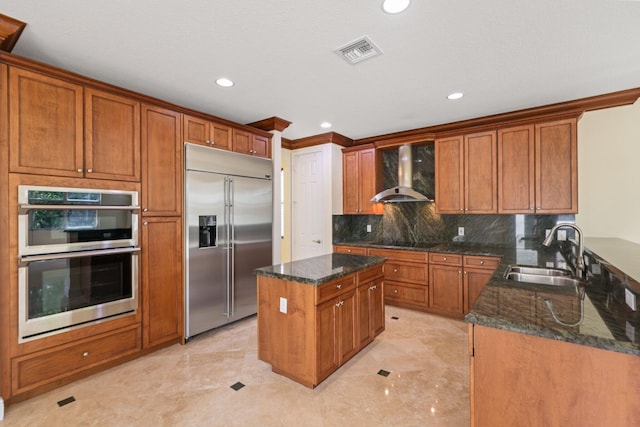 9682 Campi Dr, Lake Worth, FL 33467 - kitchen featuring dark stone countertops, visible vents, wall chimney exhaust hood, stainless steel appliances, and a sink