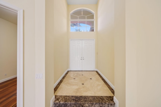 9682 Campi Dr, Lake Worth, FL 33467 - doorway to outside featuring baseboards and a towering ceiling