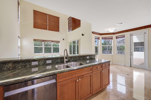 9682 Campi Dr, Lake Worth, FL 33467 - kitchen featuring dark stone counters, brown cabinetry, visible vents, dishwasher, and a sink