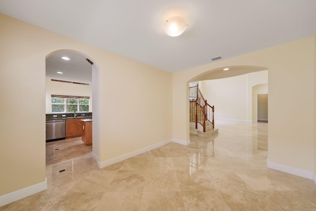 9682 Campi Dr, Lake Worth, FL 33467 - empty room featuring visible vents, baseboards, arched walkways, stairs, and marble finish floor