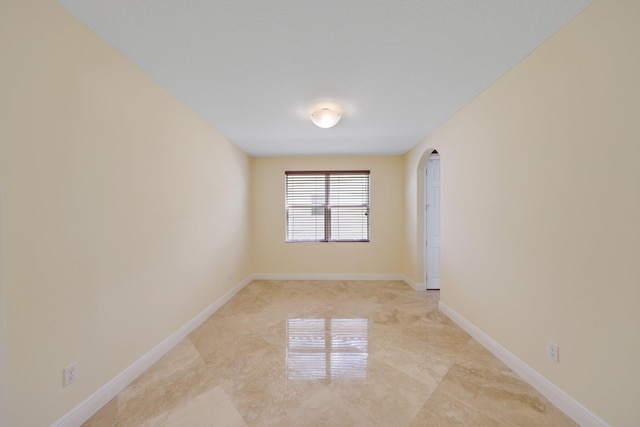 9682 Campi Dr, Lake Worth, FL 33467 - spare room with arched walkways and baseboards