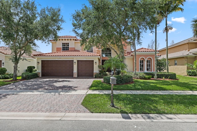 9682 Campi Dr, Lake Worth, FL 33467 - mediterranean / spanish house with a tiled roof, stucco siding, decorative driveway, a front lawn, and a garage