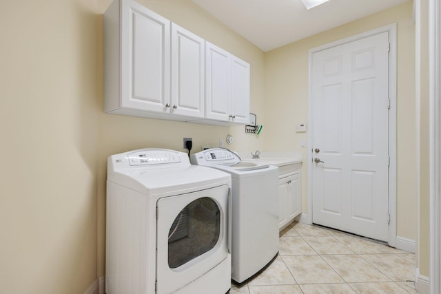 9682 Campi Dr, Lake Worth, FL 33467 - laundry room with baseboards, washing machine and clothes dryer, light tile patterned flooring, and cabinet space