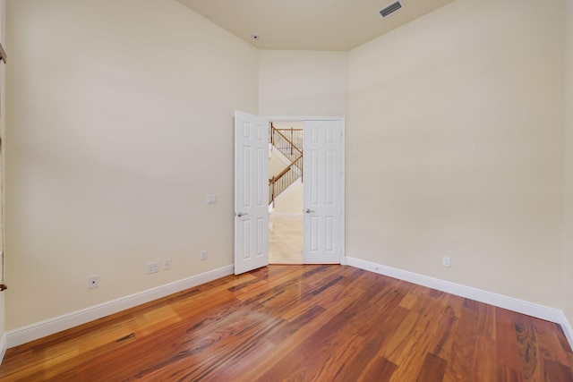 9682 Campi Dr, Lake Worth, FL 33467 - spare room with wood finished floors, baseboards, and visible vents