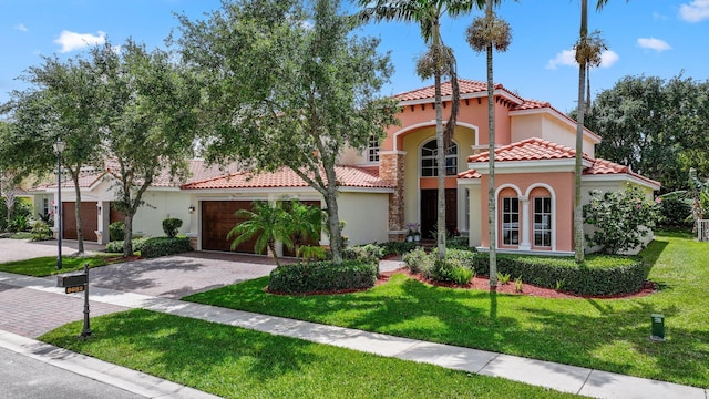 9682 Campi Dr, Lake Worth, FL 33467 - mediterranean / spanish-style house with a tiled roof, driveway, stucco siding, and a front yard