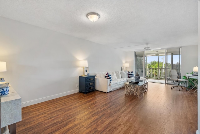 2809 Florida Blvd Unit 307, Delray Beach, FL 33483 - living room with expansive windows, baseboards, a textured ceiling, a ceiling fan, and wood finished floors