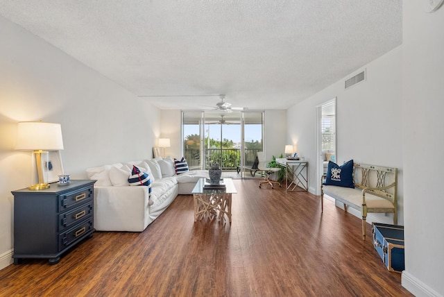 2809 Florida Blvd Unit 307, Delray Beach, FL 33483 - living area with dark wood finished floors, a textured ceiling, a ceiling fan, visible vents, and a wall of windows