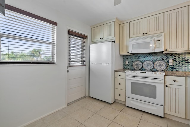 2809 Florida Blvd Unit 307, Delray Beach, FL 33483 - kitchen featuring tasteful backsplash, cream cabinets, white appliances, and light tile patterned floors
