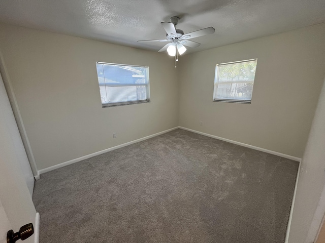 unfurnished room with baseboards, ceiling fan, carpet floors, and a textured ceiling