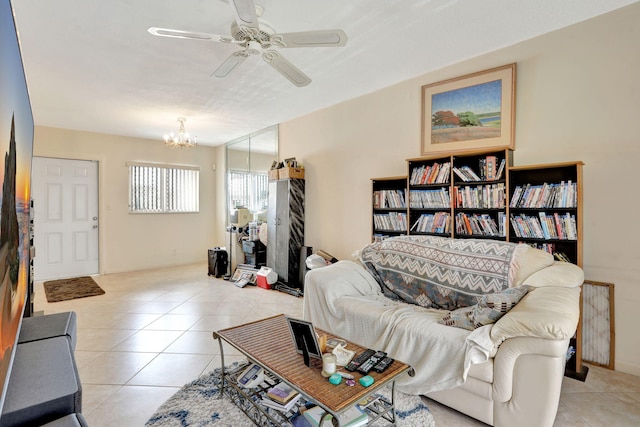 1021 Crystal Lake Dr Unit 109, Deerfield Beach, FL 33064 - tiled living area featuring ceiling fan with notable chandelier and radiator