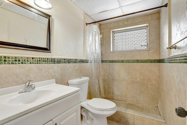 1021 Crystal Lake Dr Unit 109, Deerfield Beach, FL 33064 - bathroom featuring toilet, vanity, tile walls, and a tile shower