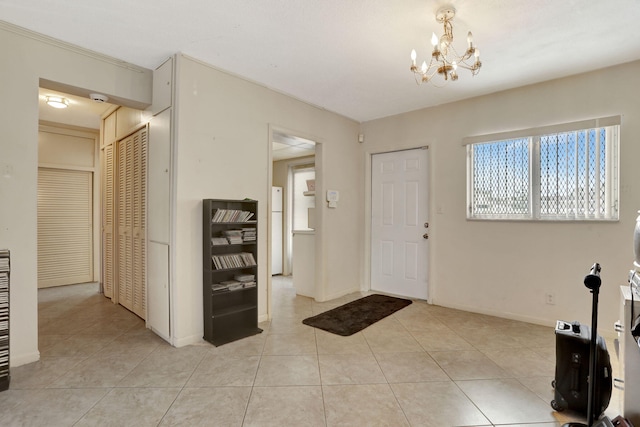 1021 Crystal Lake Dr Unit 109, Deerfield Beach, FL 33064 - entrance foyer featuring light tile patterned flooring, baseboards, and an inviting chandelier