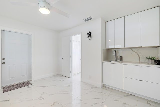 180 NW 18th St, Pompano Beach, FL 33060 - kitchen with light countertops, visible vents, marble finish floor, and a sink
