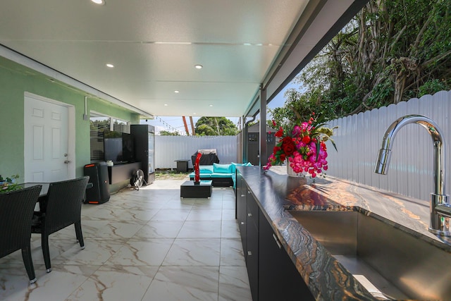 180 NW 18th St, Pompano Beach, FL 33060 - view of patio / terrace with an outdoor living space, a fenced backyard, and a sink