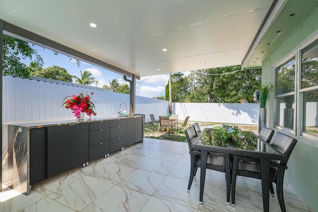 180 NW 18th St, Pompano Beach, FL 33060 - view of patio / terrace featuring outdoor dining space, a fenced backyard, and a sink