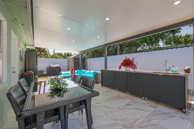 180 NW 18th St, Pompano Beach, FL 33060 - view of patio featuring outdoor lounge area, a shed, a fenced backyard, an outbuilding, and a sink