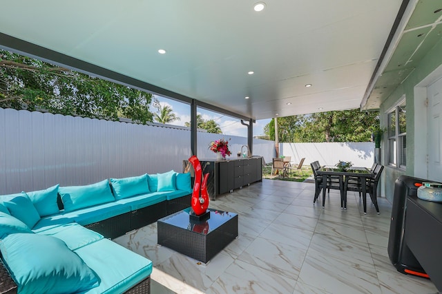 180 NW 18th St, Pompano Beach, FL 33060 - view of patio with a sink, an outdoor hangout area, a fenced backyard, and outdoor dining area