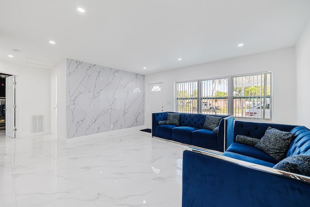 180 NW 18th St, Pompano Beach, FL 33060 - living room with stone wall, an accent wall, visible vents, recessed lighting, and marble finish floor