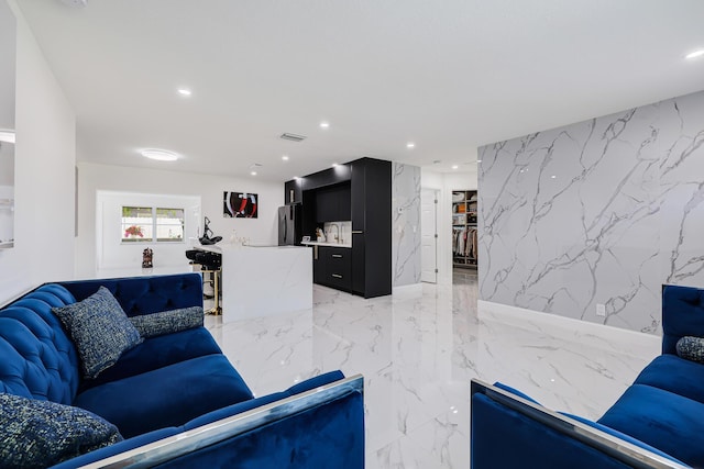 180 NW 18th St, Pompano Beach, FL 33060 - living room with visible vents, stone wall, marble finish floor, and recessed lighting
