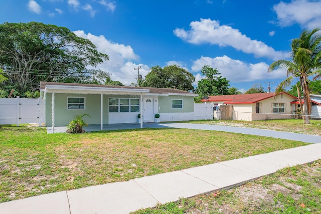 180 NW 18th St, Pompano Beach, FL 33060 - view of front of property with concrete driveway, stucco siding, a gate, a front yard, and fence
