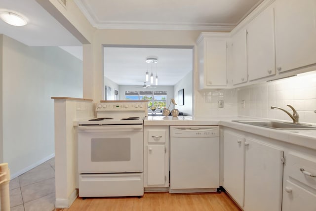 1502 S Lakeside Dr Unit 318, Lake Worth, FL 33460 - kitchen with white appliances, a sink, white cabinetry, decorative backsplash, and tile counters