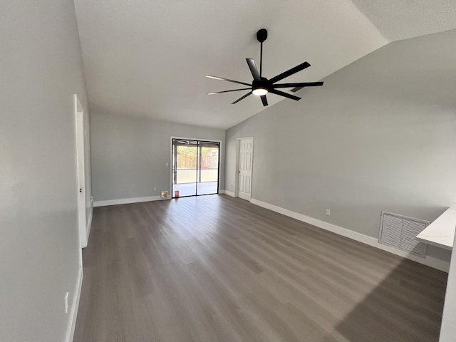 unfurnished room featuring dark wood-style flooring, visible vents, baseboards, ceiling fan, and lofted ceiling