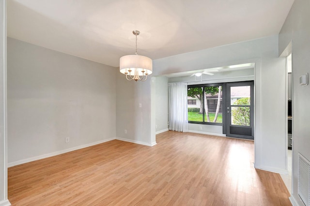 9805 Walnut Tree A Way Unit A, Boynton Beach, FL 33436 - empty room with baseboards, light wood finished floors, and ceiling fan with notable chandelier