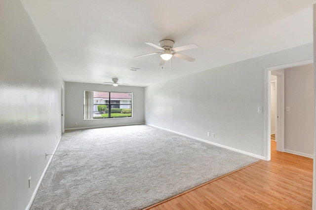 9805 Walnut Tree A Way Unit A, Boynton Beach, FL 33436 - empty room with visible vents, baseboards, light wood-style floors, light colored carpet, and a ceiling fan