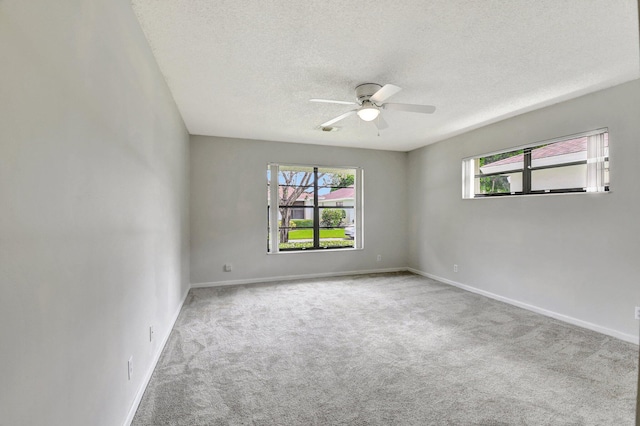 9805 Walnut Tree A Way Unit A, Boynton Beach, FL 33436 - carpeted empty room with baseboards, a ceiling fan, a textured ceiling, and plenty of natural light
