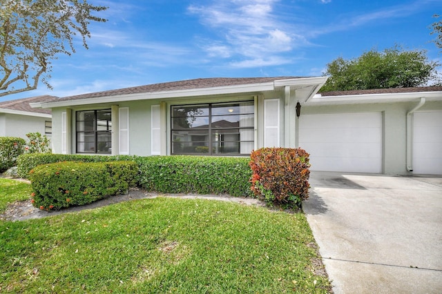 9805 Walnut Tree A Way Unit A, Boynton Beach, FL 33436 - view of front facade with a garage, stucco siding, a front yard, and concrete driveway