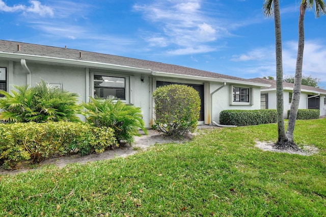 9805 Walnut Tree A Way Unit A, Boynton Beach, FL 33436 - ranch-style house with a front lawn and stucco siding