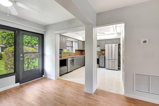 9805 Walnut Tree A Way Unit A, Boynton Beach, FL 33436 - kitchen with visible vents, a ceiling fan, gray cabinetry, tasteful backsplash, and appliances with stainless steel finishes
